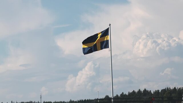 Stockholm, Sweden A Swedish flag blows in the wind on a flagpole. 