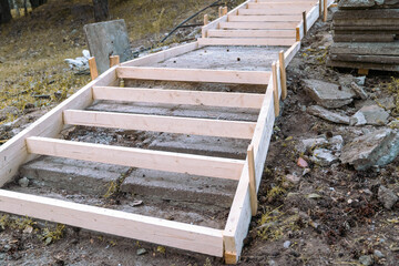 Construction workers building concrete stairs using wooden formwork