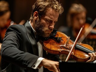 A world-renowned classical musician plays the violin with intense focus and passion. He is part of an orchestra, and the warm, dramatic lighting captures the emotion of the performance