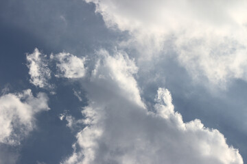Blue sky with white clouds - contrast between the depth of the blue and the sun's rays