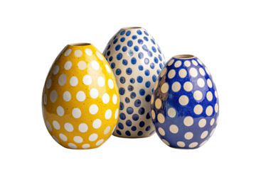 Three ceramic vases, egg-shaped, decorated with polka dots.  Yellow, blue, and blue/white polka dot patterns