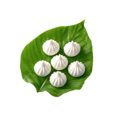 Traditional Indian modaks placed neatly on a fresh green banana leaf, festive sweet for Ganesh Chaturthi celebration, on transparent background