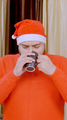 Vertical Photo of Indian Man Drinking Coffee with Christmas Tree in background