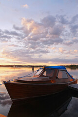 The colors of the sunset and boat at lakeside