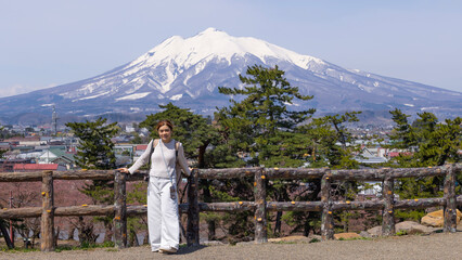woman have a view in front of Mount Iwaki,  it is the highest mountain in Aomori Prefecture, Japan