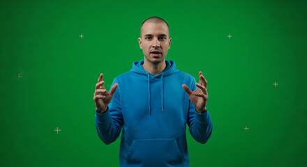 Man in blue hoodie against green screen