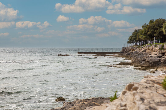 Mediterranean coastal landscape with rocky cliffs and pier. Istria, Croatia. - Powered by Adobe