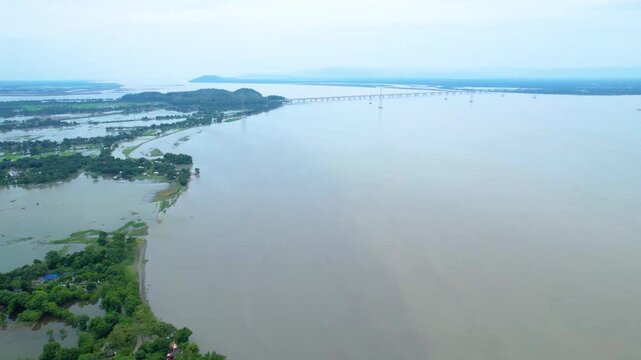 4K Aerial View of Wide River, Bridge, and Flooded Landscape
