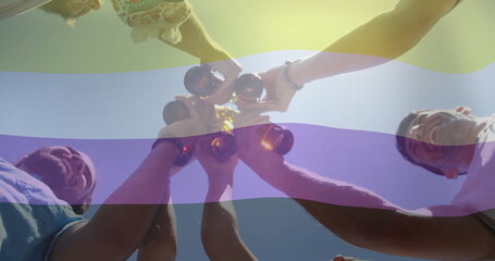 Five friends clinking brown beer bottles outdoors under clear sky, wearing summer tops, bracelets