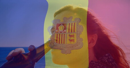 Drinking woman holding dark glass bottle to lips at beach, with tricolor overlay