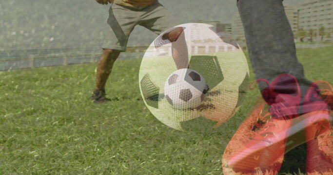 Kicking red cleat striking soccer ball on grassy field in sportswear by water, with metal railing - Powered by Adobe
