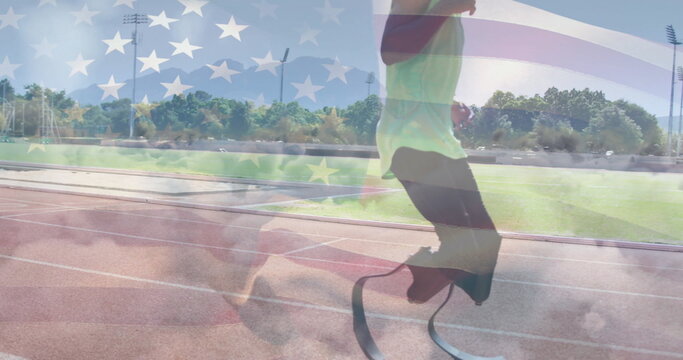 Sprinting athlete in green top on red track, prosthetic blades with US flag overlay, copy space