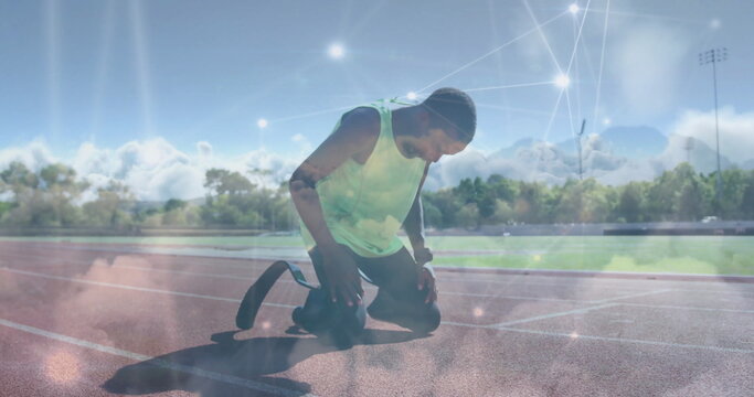 Kneeling teenage athlete adjusting prosthetic blade at start line, with light overlay - Powered by Adobe