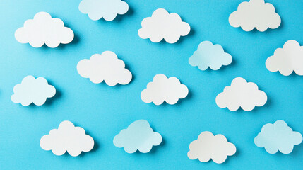Fototapeta premium Paper clouds scattered on a blue background