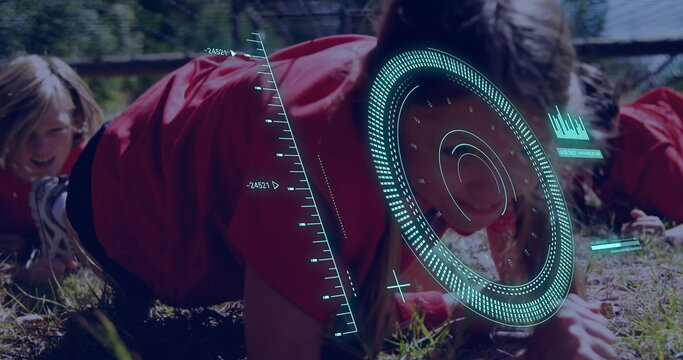 Crawling kids in red-and-black sportswear under rope net on grassy field, with teal HUD overlay