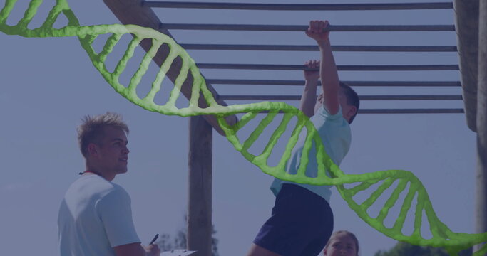 Hanging boy in sportswear gripping monkey bars at fitness area, with clipboard and DNA helix