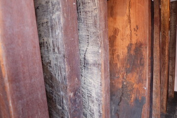 Old, large wooden planks in dark brown color are laid side by side, showcasing beautiful wood grain...