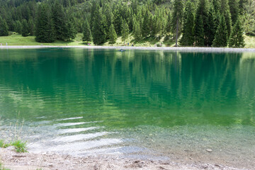 A captivating view of a tranquil mountain lake nestled amidst the majestic Bavarian Alps