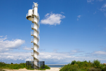 Obraz premium Tall Telecommunication Tower With Spiral Staircase Against Clear Sky