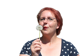Red-haired woman with dandelion in her hands on the nature	