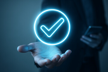 Digital check mark symbol floating above open hand showing secure approval verification concept in futuristic smart interface mobile technology background