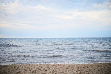 Calm sea under cloudy sky at sunset time