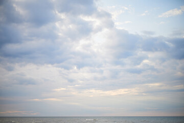 Calm sea under cloudy sky at sunset time