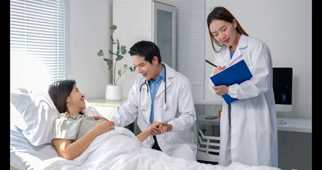A woman is laying in a hospital bed with a doctor