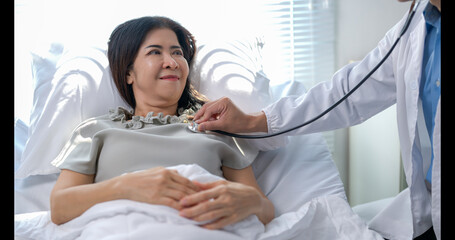 A woman is being checked by a doctor