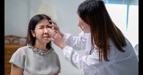 A woman is getting her eye checked by a doctor