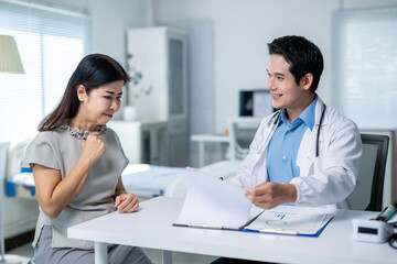 A doctor is talking to a woman in a hospital room