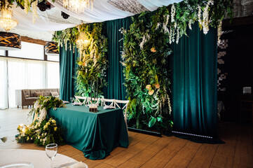 Luxurious restaurant. Luxurious interior, white tables, serving dishes and glasses for newlyweds....