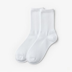 Blank white cotton socks laid flat on white background