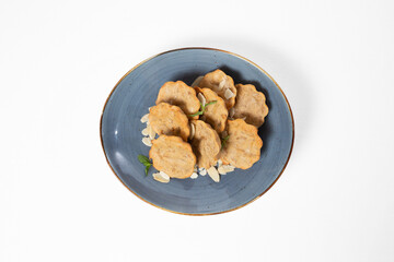 Almond muffins on a plate on a white background