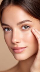 Young Woman Applying Concealer on Skin with Gentle Touch in Close-Up Portrait