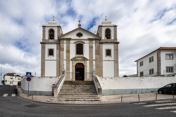 Obraz premium Old Sao Pedro Church facade and staircase in Palmela, Portugal under a blue cloudy sky near Setubal