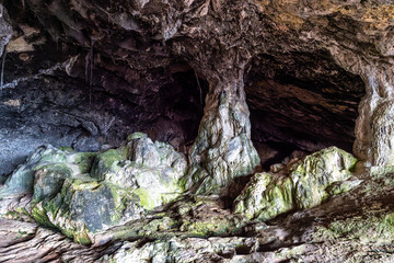 Dark interior of Lapa de Santa Margarida in Arrabida, Setubal, Portugal. Cave with small chapel of spontaneous worship