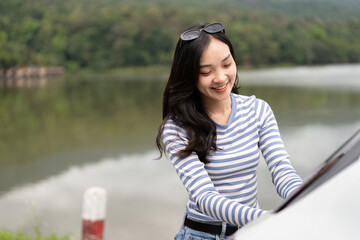 Young woman smiling while preparing for a road trip
