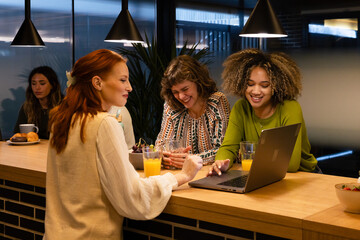 Colleagues enjoying break time with laughter over drinks