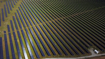 Solar Farm Aerial View Technology Sustainable Funding - Aerial view of solar panels installed across the field. Concept of green energy subsidies, renewable technology advancements, and financing for  - Powered by Adobe