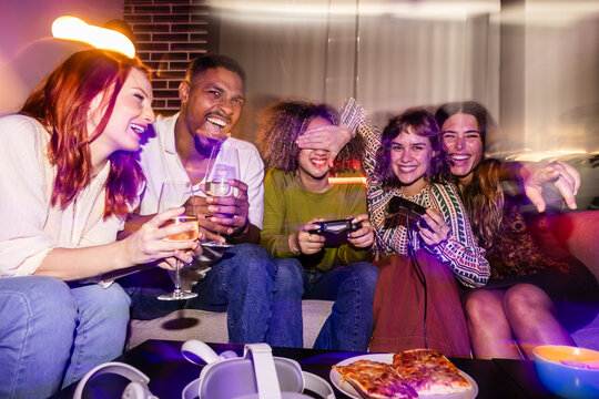 Friends enjoying a fun video game night together - Powered by Adobe