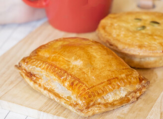 Ham and Cheese Puff Pastry on Wooden Board side view of Savory Baked Snack