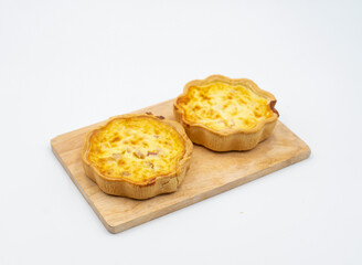 Golden Quiche Lorraine Tarts on Wooden Board side view of Savory French Pastries