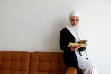 attractive muslim woman reading book	
