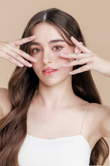 Naklejka premium Beautiful portrait Caucasian woman makeup of cosmetic on face smile attractive isolated on beige background.