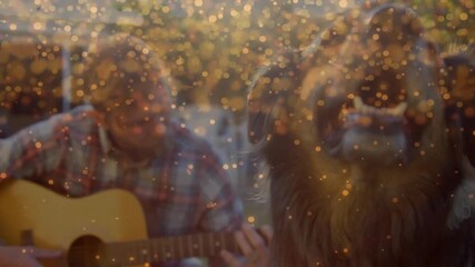 Musician adjusting fretboard playing guitar on sunset patio sparkles swirling and dog sniffing lens - Powered by Adobe