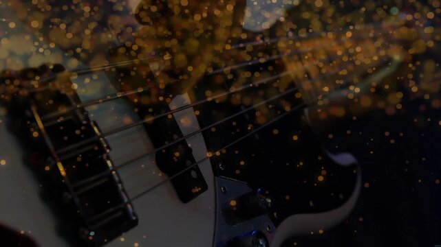 Musician plucking white electric bass guitar causing gold dust drifting highlighting frets pickups