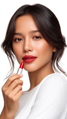 Southeast Asian Model Applying Red Lipstick with a Confident Expression in a Bright Setting