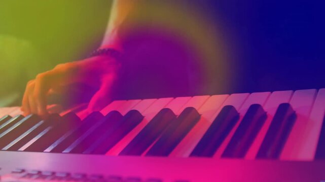 Performer hand entering and playing chord and arpeggios in music with neon flares pulsing in rhythm