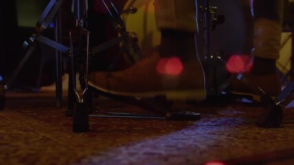 Drummer's right foot pressing pedal with ball of foot, driving bass drum beater and accenting beats - Powered by Adobe